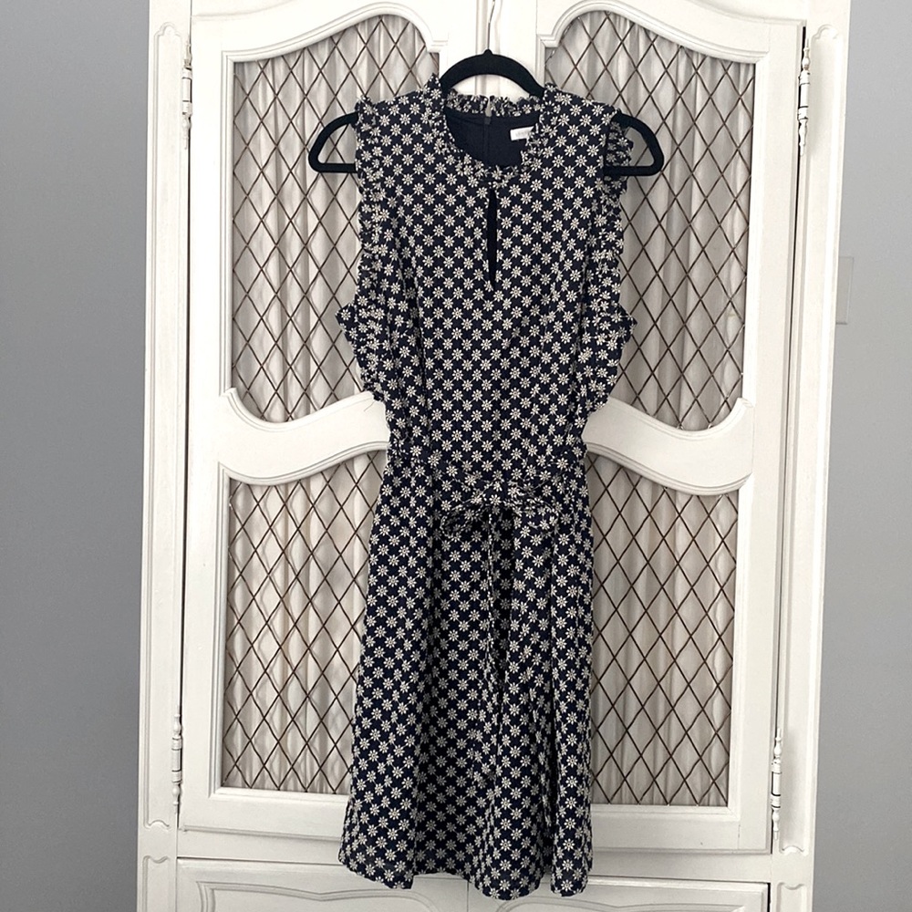 Adorable navy dress with embroidered daisy details.